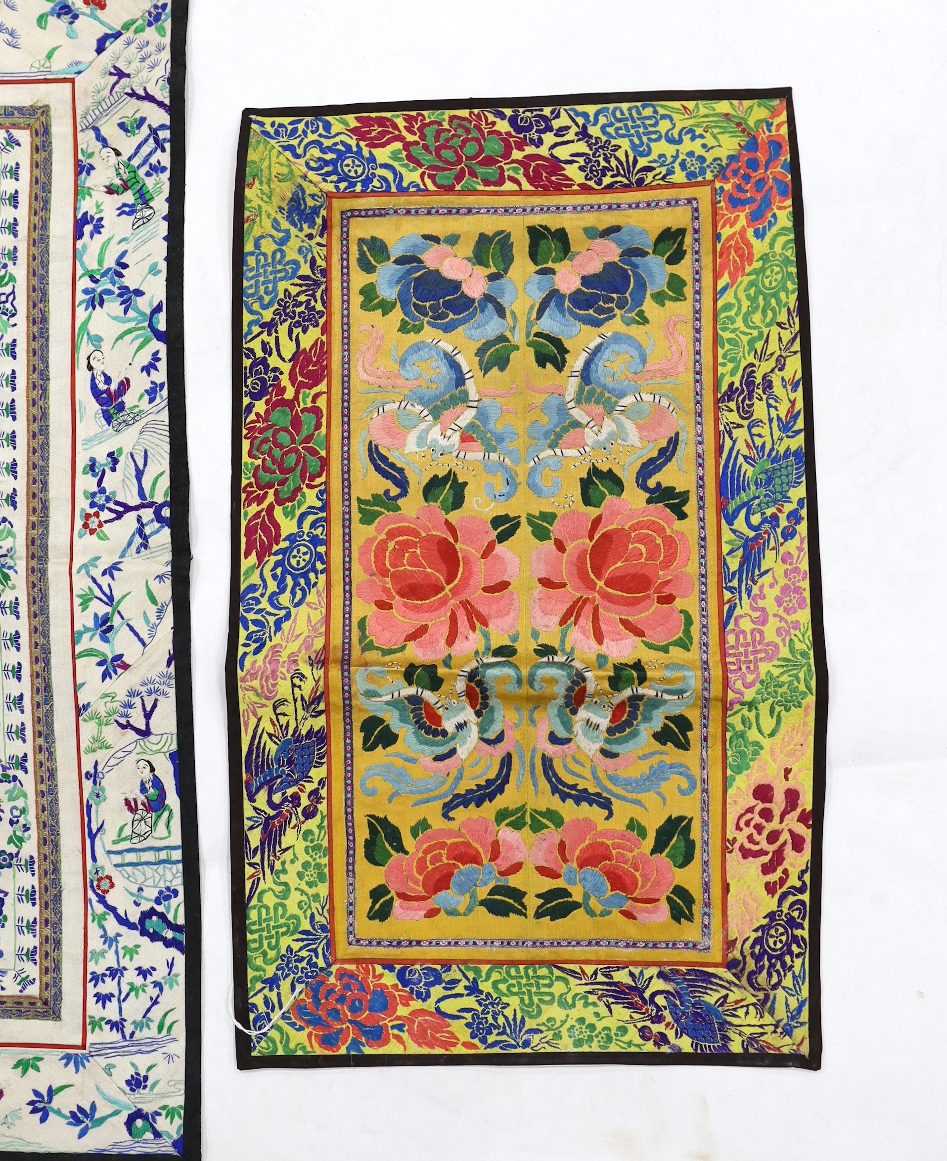 Four pairs of Chinese sleeve bands, two embroidered with figures on cream silk, a pair of floral embroidered on gold silk and the other polychrome flowers on blue silk, three with brocade borders, two largest 69cm high x